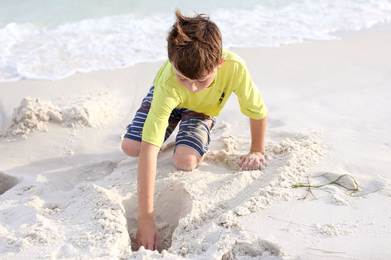 Boy making sandcastle at beach