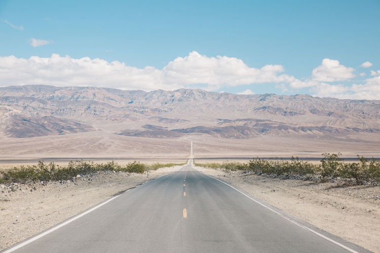 Road amidst landscape against sky
