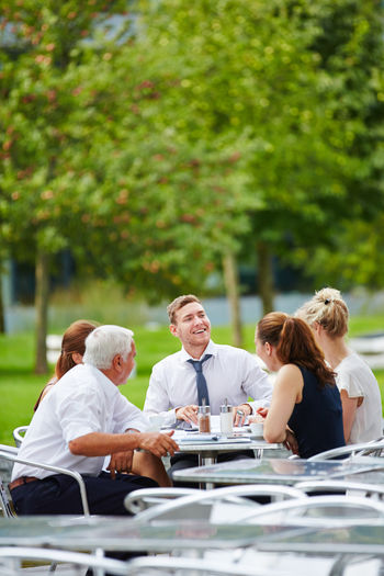 Business people discussing at outdoor cafe