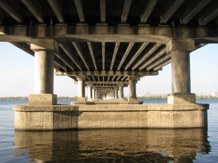 Below view of bridge over river against sky