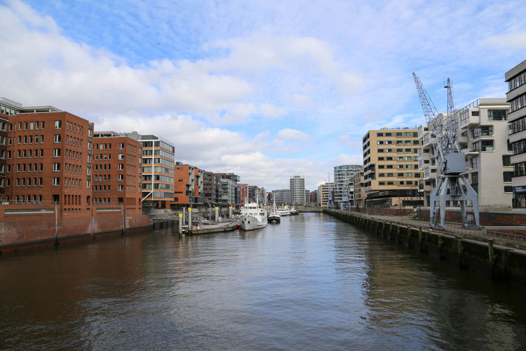 River amidst buildings against sky in city
