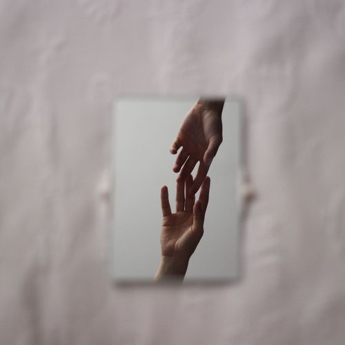 Close-up of hand on white wall