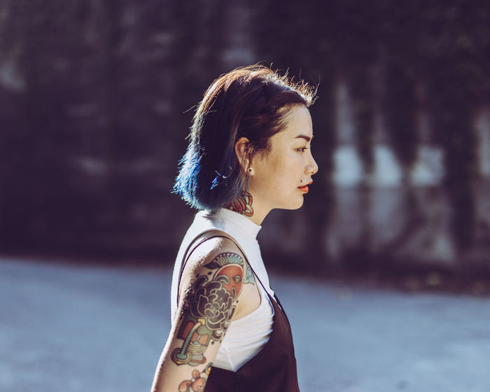 Profile view of woman with tattoo on shoulder