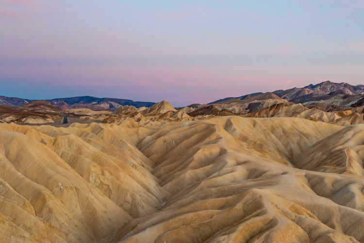 Looking out over zabriskie point at sunset, in death valley national park