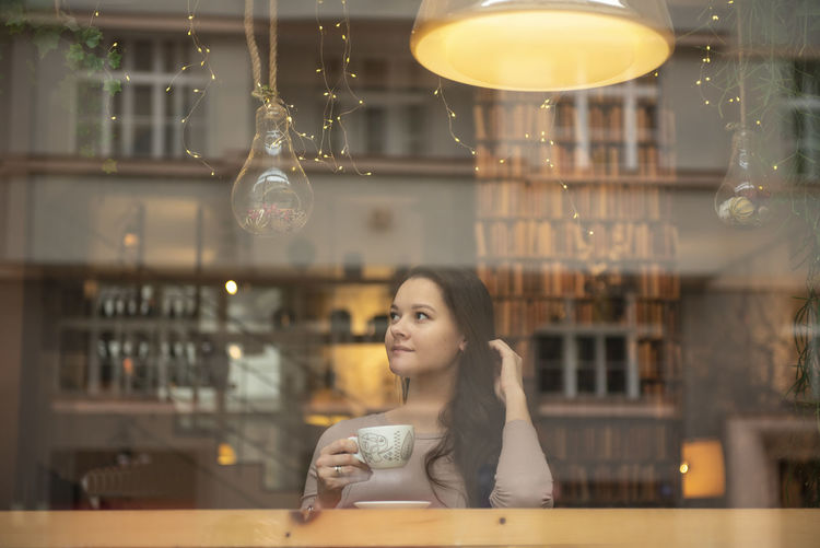 Woman having coffee at cafe
