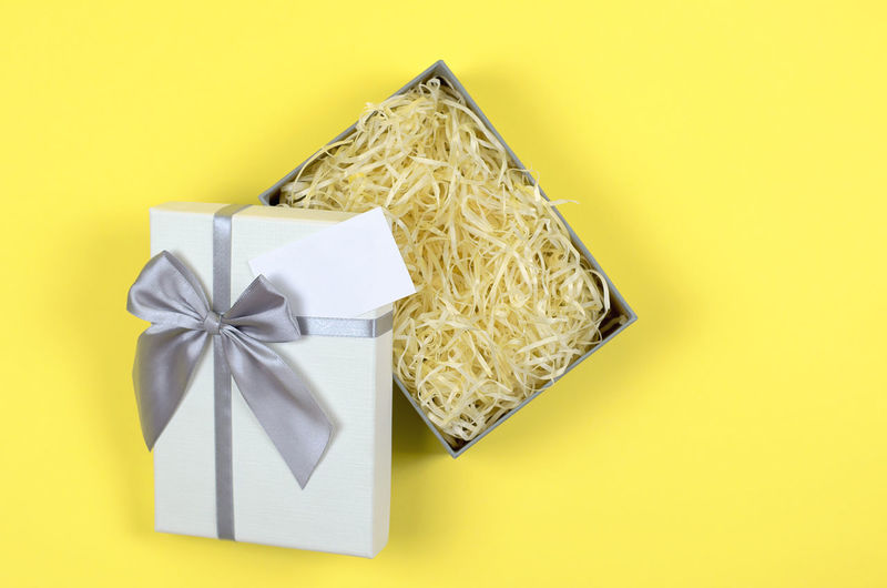 High angle view of gift box on yellow background