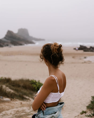 Woman on the beach on a cloudy day 