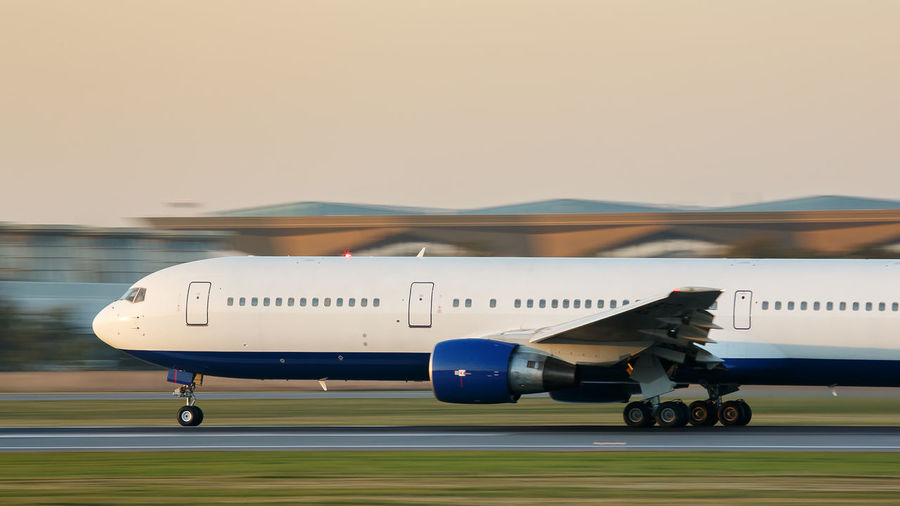 Airplane on airport runway against clear sky