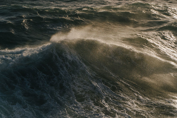 Full frame shot of sea and wave in golden light 