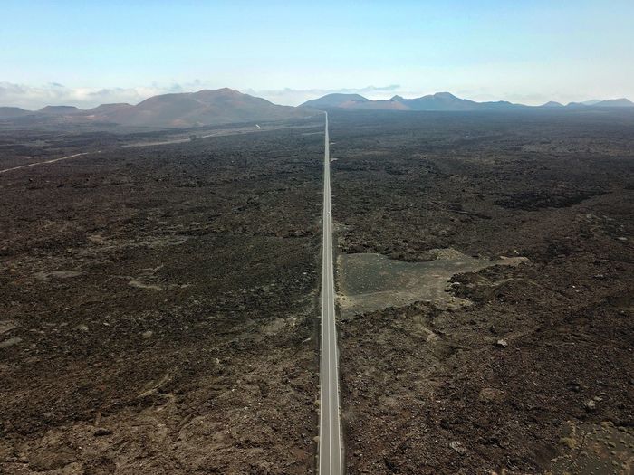 Aerial view of road on landscape against sky