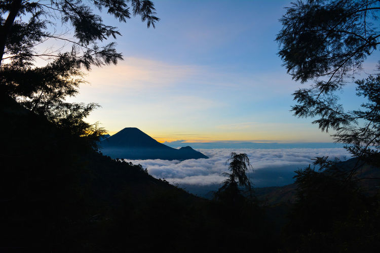 Scenic view of silhouette mountains against sky at sunset