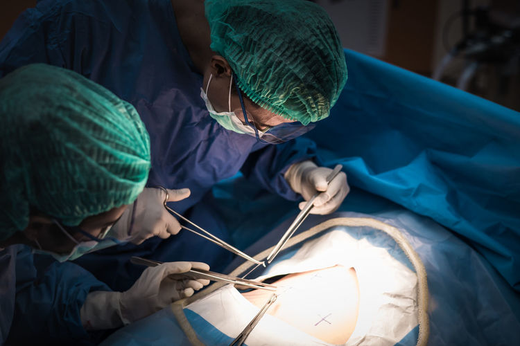 Surgeons performing surgery in operating room