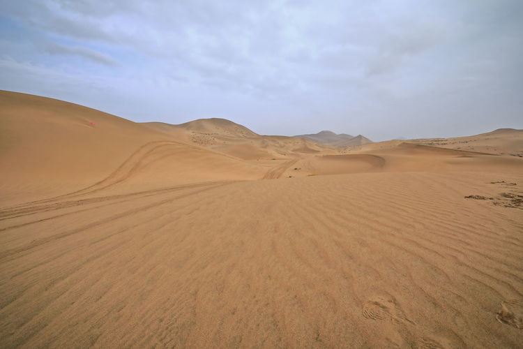 1027 moving and stationary sand dunes-badain jaran desert -tire tracks on the sand. nei mongol-china