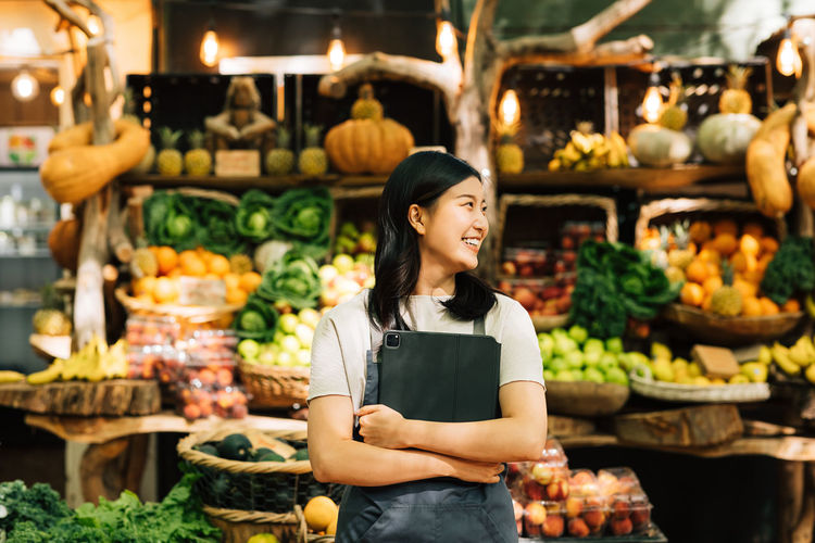 Portrait of young woman standing in market