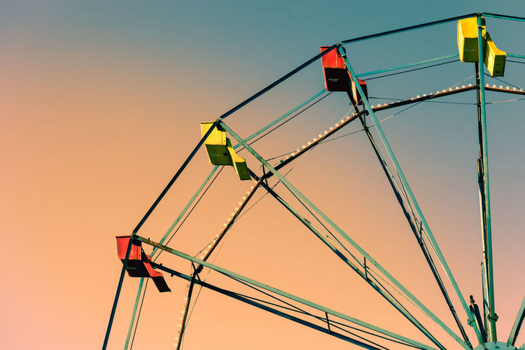 Low angle view of illuminated ferries wheel against clear sky