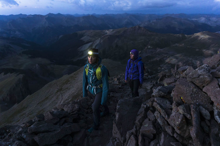 Female hikers on mountain at dusk