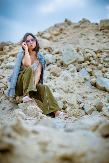 Beautiful woman sitting on rocks