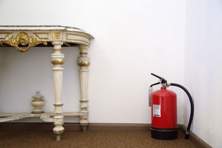 Fire extinguisher beside wooden table