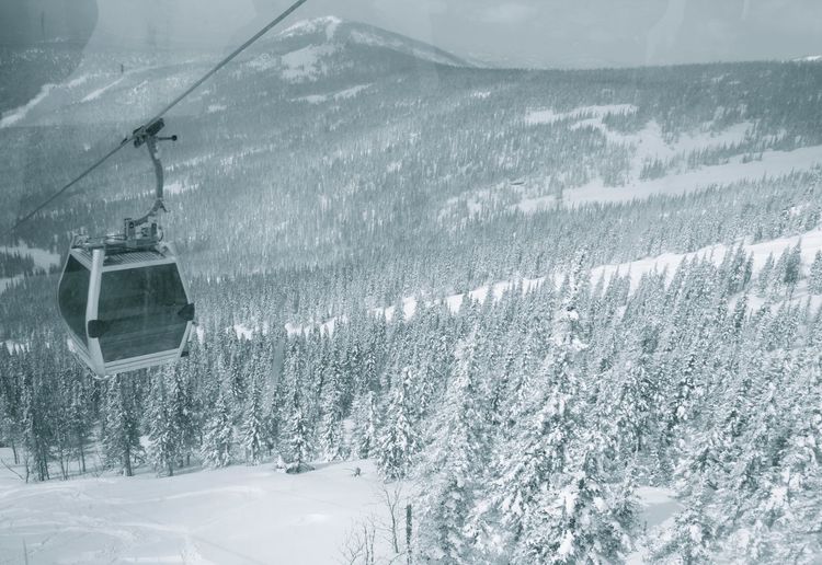 Overhead cable car on snow covered mountain