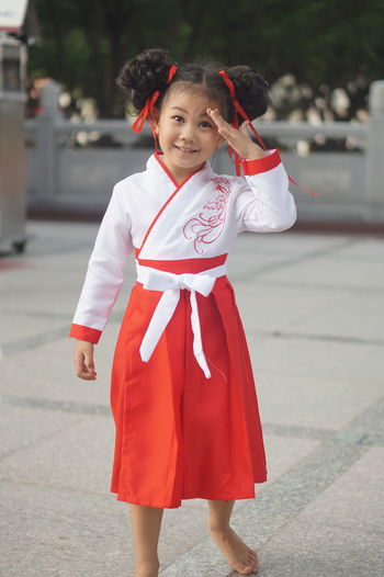 Portrait of a smiling girl standing outdoors