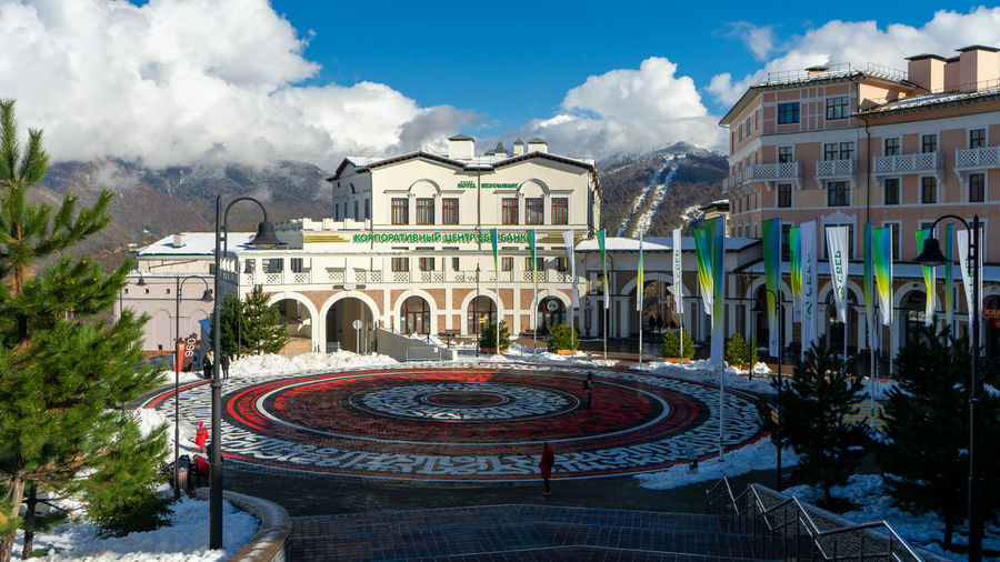 Buildings in city against cloudy sky