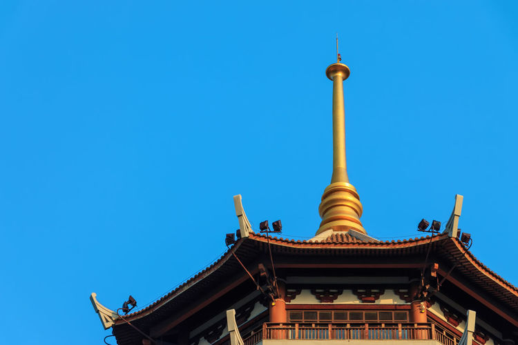 Low angle view of traditional building against clear blue sky on sunny day