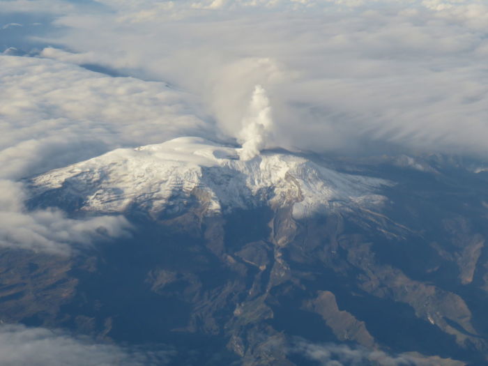 Aerial view of clouds over mountains against sky