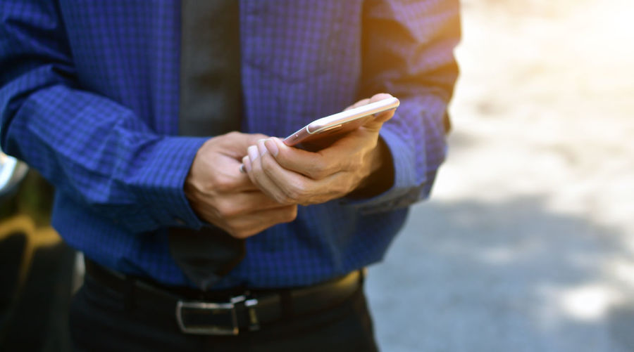 Businessman holding mobile smartphone technology