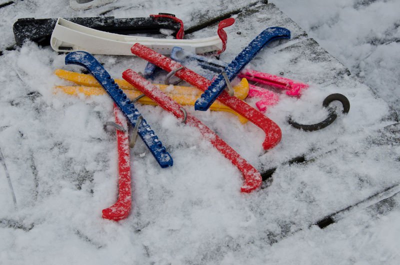 High angle view of colorful skate guards on snow