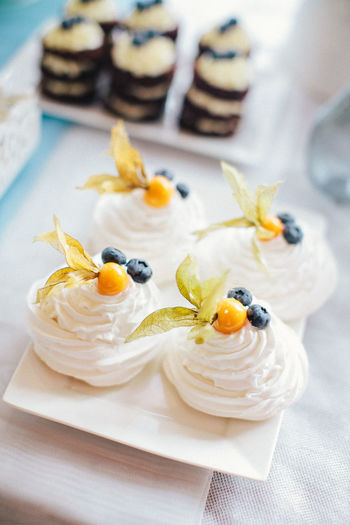 White pavlova cakes with blueberry and fruits