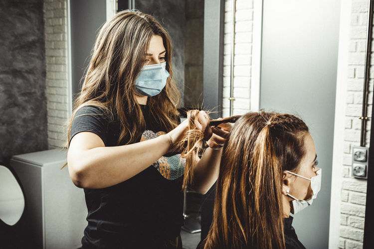 Beautician and hairdresser working with mask for the covid19 virus