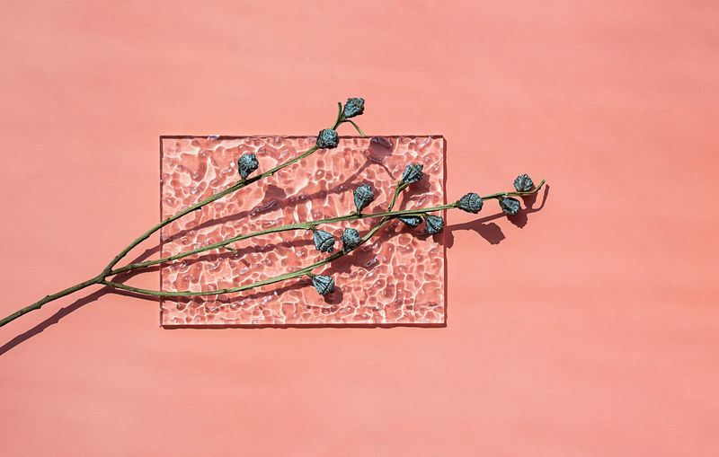 High angle view of figurines on pink background