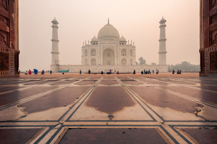 People in front of taj mahal during sunset