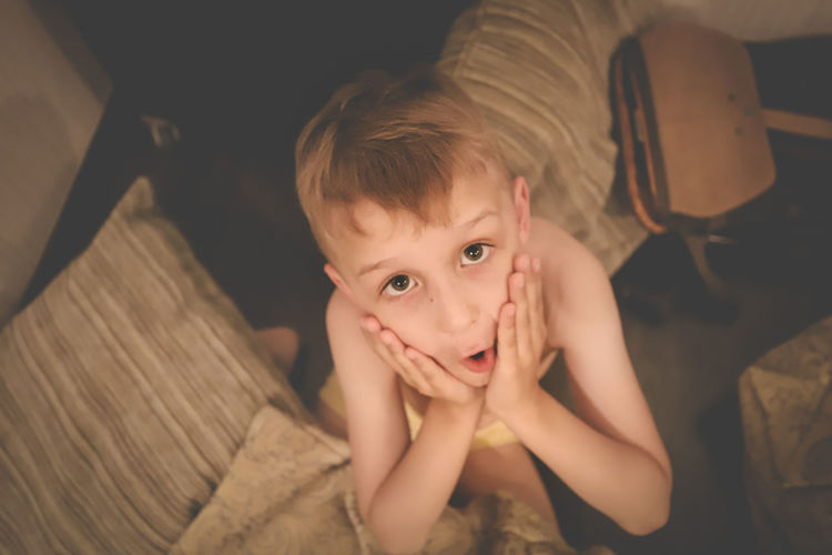 Portrait of surprised boy at home