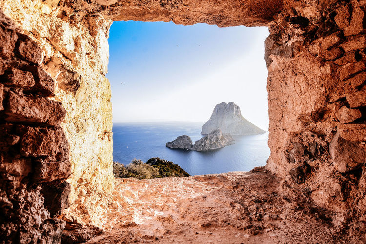 Scenic view of sea against sky seen through rock formation