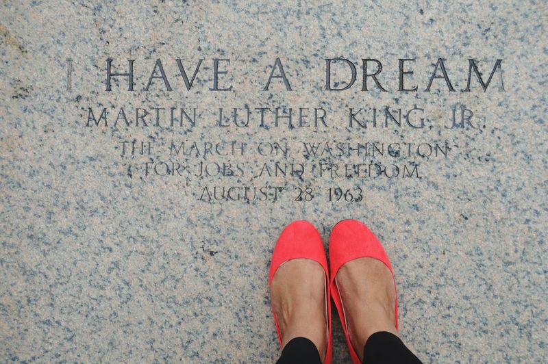 Low section of woman standing at martin luther king jr memorial