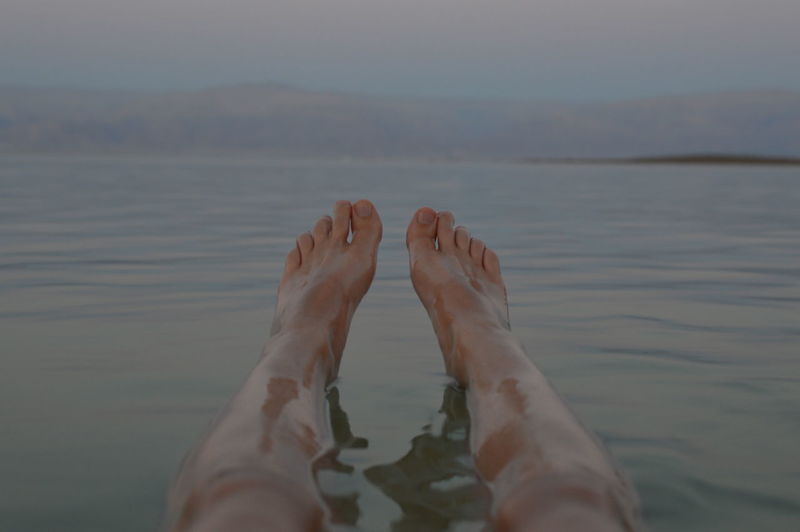 Low section of man relaxing in sea
