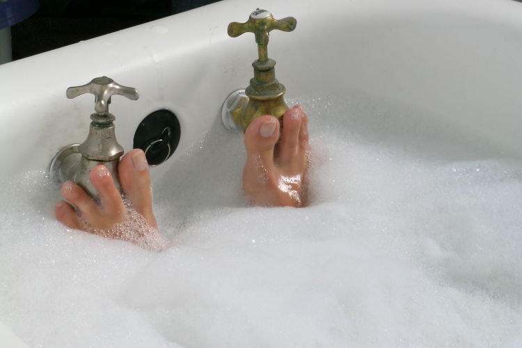 Close-up of feet during a bubble bath
