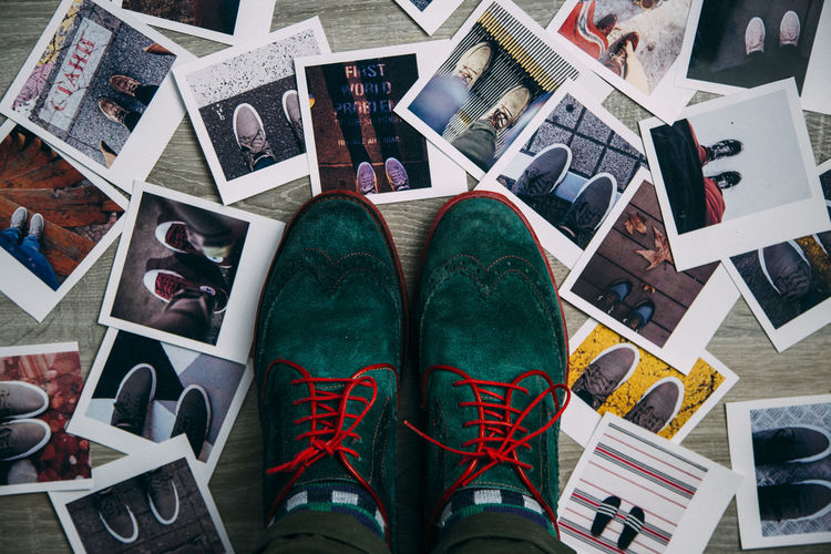 High angle view of shoes by photographs on table