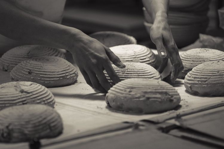 Cropped image of baker making bread at bakery