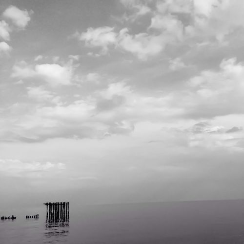 Scenic view of sea against cloudy sky