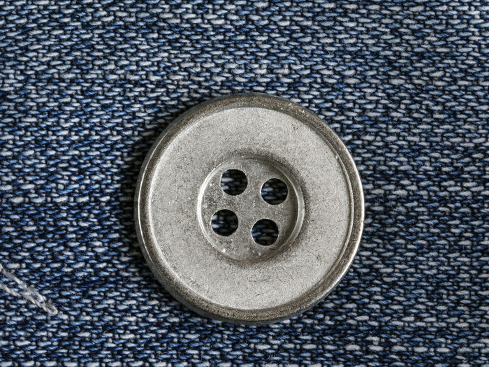 Close-up of button on jeans