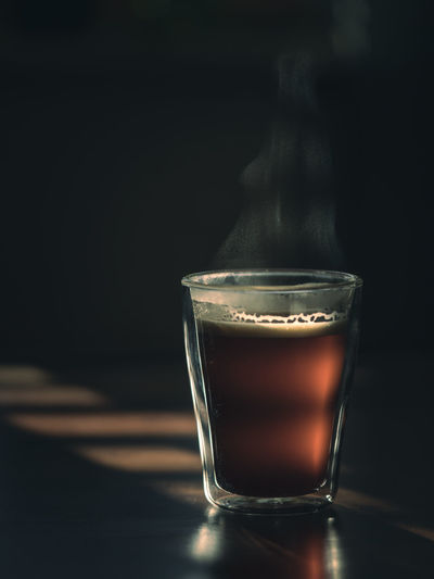 Close-up of coffee on table against black background
