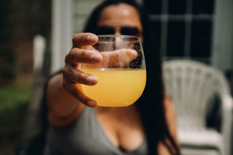 Close-up of woman drinking glass