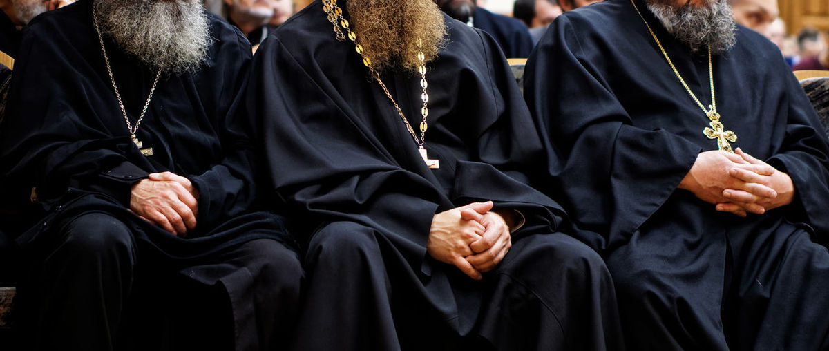 Midsection of priests at church