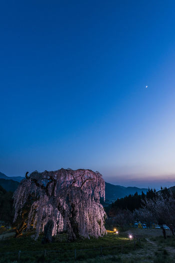 View of rock formation against clear blue sky at dusk