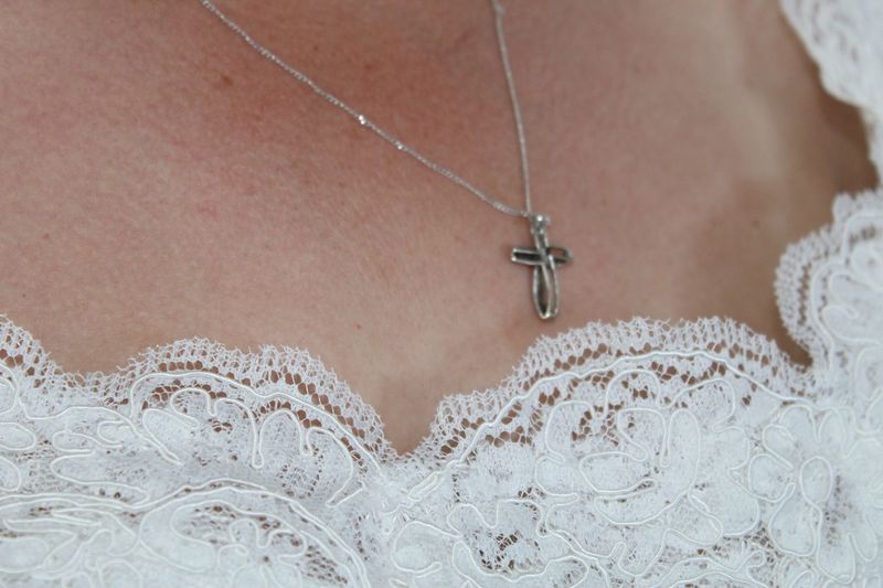 Close-up of woman wearing cross pendant