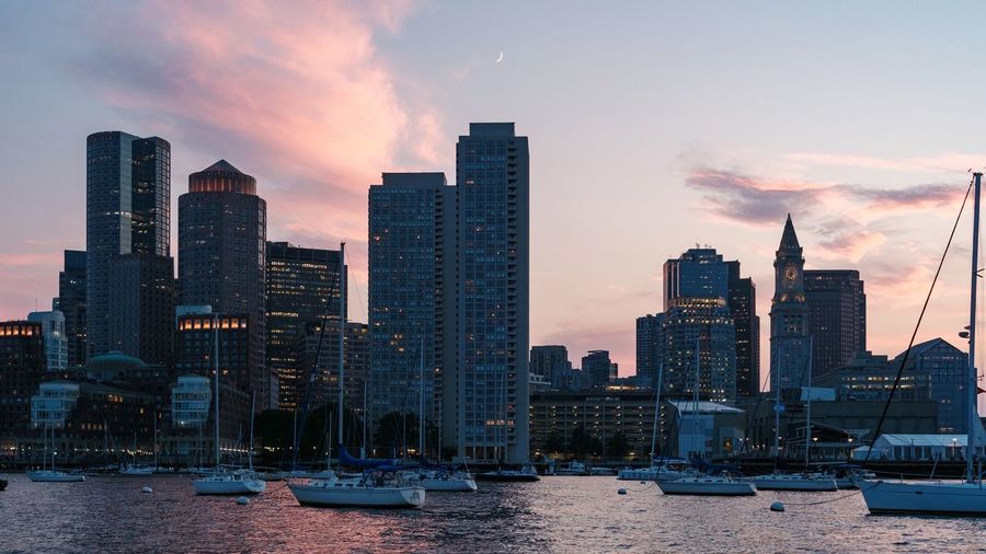 Boston's modern buildings in city against sky during sunset