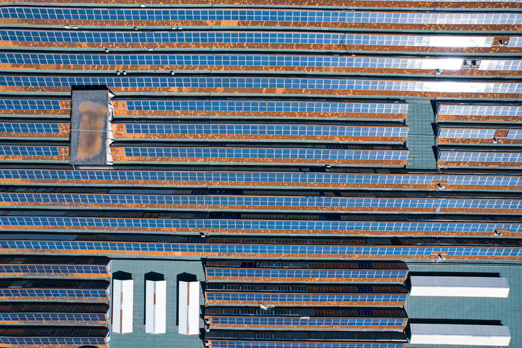 Solar panels on the roof of a large industrial building.