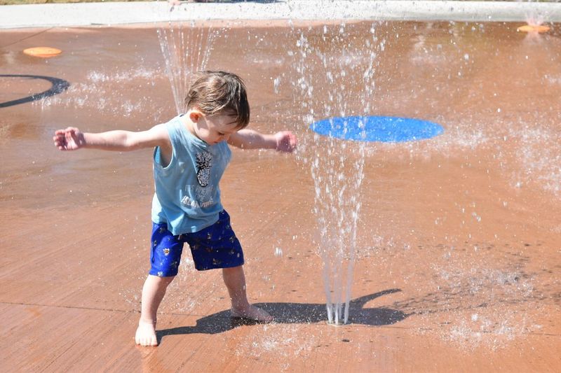 Full length of boy enjoying fountain